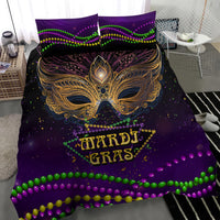 Mardi Gras bedding set with gold phoenix mask, MARDI GRAS text, green and pink bead lines.