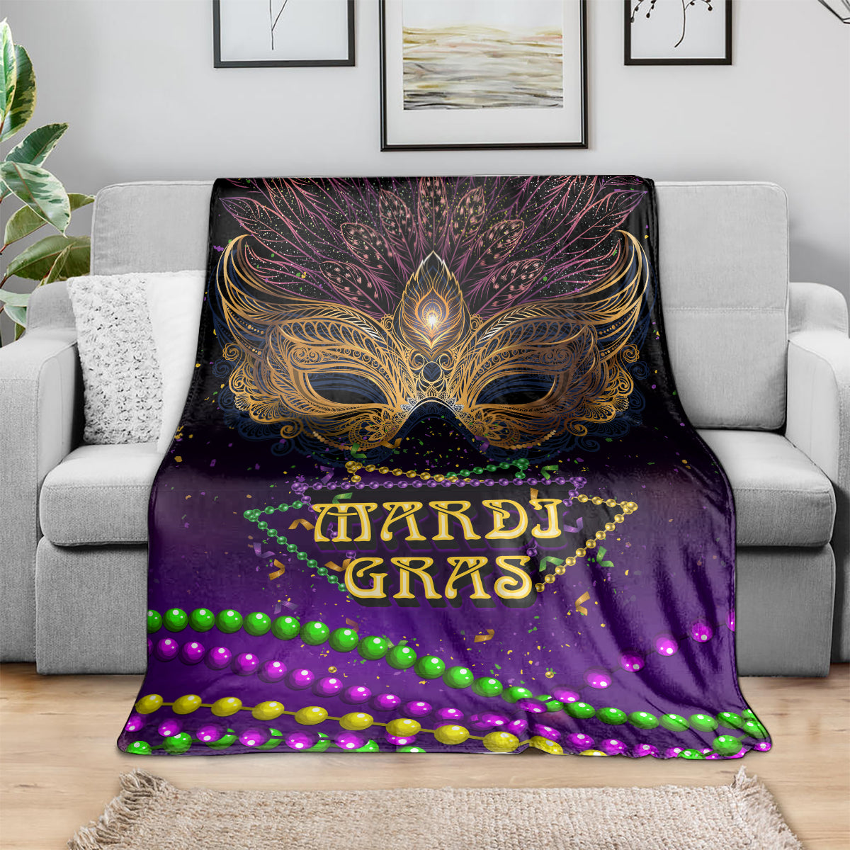 Purple Mardi Gras carnival mask blanket spread on sofa, with gold mask and neon beads