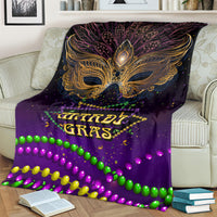 Purple Mardi Gras carnival mask blanket draped on couch, gold crest and multicolor bead garland