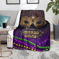 Purple Mardi Gras carnival mask blanket with gold mask emblem and bright green, pink bead trim