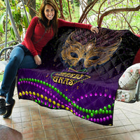 Purple Mardi Gras quilt held up indoors, showing gold bird mask and beaded wave trim