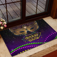 Purple carnival doormat with gold feather mask and HARDI GRAS logo, green and purple bead border