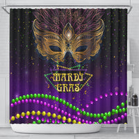 Purple shower curtain featuring golden feather mask, Mardi Gras text, and green/pink bead border