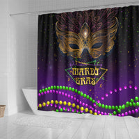 Purple shower curtain with ornate gold mask above Mardi Gras lettering and bright bead garland