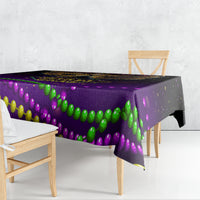 Purple Mardi Gras tablecloth with multicolor bead pattern, draped over table edge