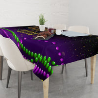 Purple Mardi Gras tablecloth with green and purple bead garland print over dining table