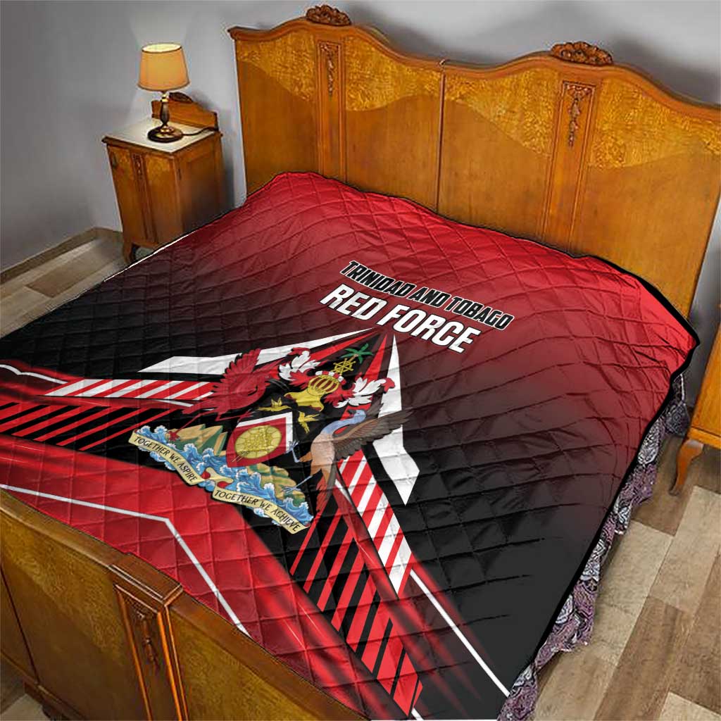 Red and black quilt on bed with Trinidad and Tobago Red Force emblem in center