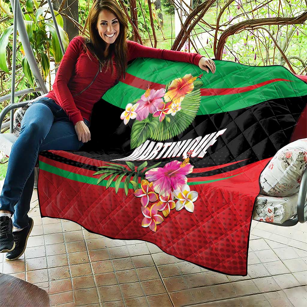Quilted tropical blanket mat draped on a couch outdoors; green, black, red floral design