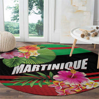 Round black carpet mat with MARTINIQUE logo-style text and vibrant flower and leaf print