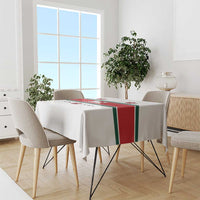 White tablecloth with red, green stripes and crest graphics on dining table