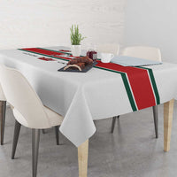 White tablecloth with red-and-green trim and crown and horse print across center