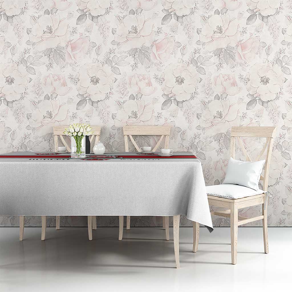 White tablecloth featuring red-green border and crown and horse graphics