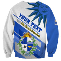Gray sweatshirt with “YOUR TEXT” graphic, Uruguay flag shield, wreath and sun