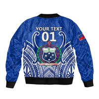Blue bomber jacket with full-zip back graphic, black rib trim, crest with 01 and red flag patch.