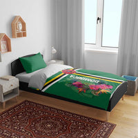 Green duvet and pillow set with tropical bloom graphic, Dominica text, and striped center