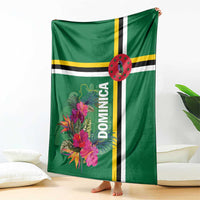 Green blanket with tropical flowers, Dominica text, and vertical striped bands