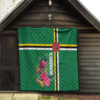 Green quilt with tropical flower print, striped bands, and vertical Dominica text