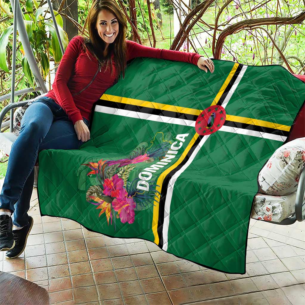 Green quilt on sofa with tropical floral print, striped bands, and Dominica text stripe