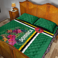 Green quilt bed set with striped band, tropical floral print, and DOMINICA lettering; two pillows