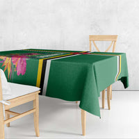 Green tablecloth draped over chair and table edge, tropical floral corner.