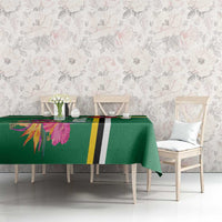 Green tablecloth with tropical flowers and black-yellow stripe on dining set.