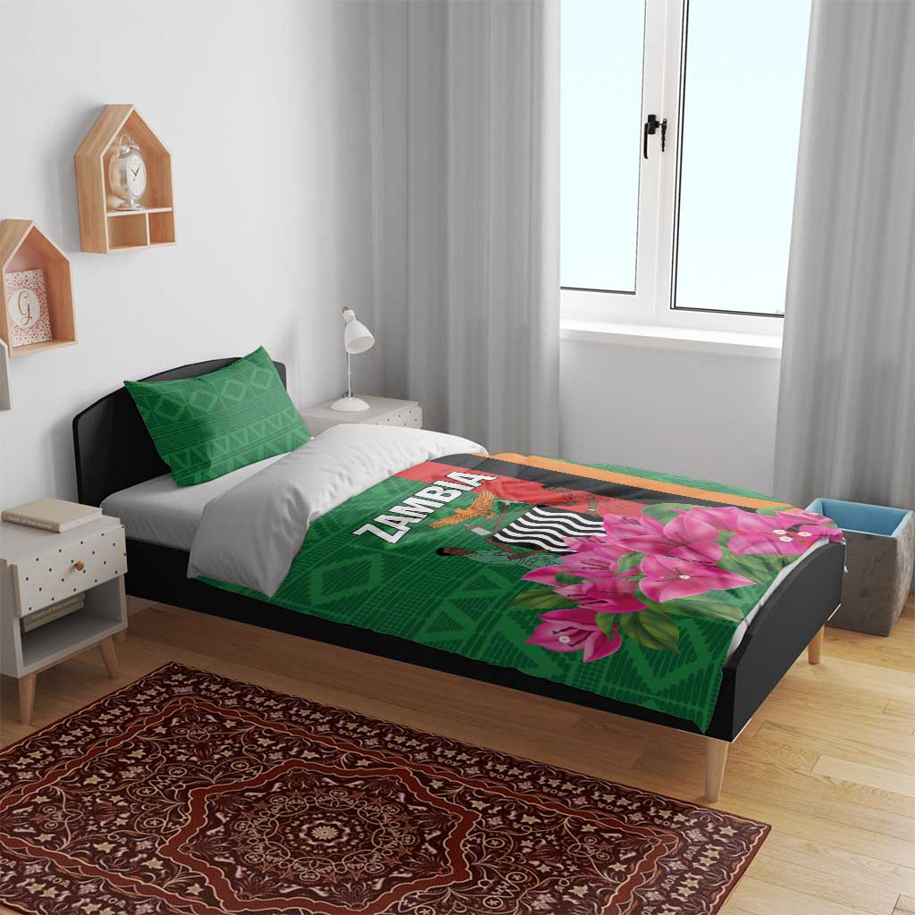 Green bedding set on bed with pink bougainvillea graphic and matching green pillowcases
