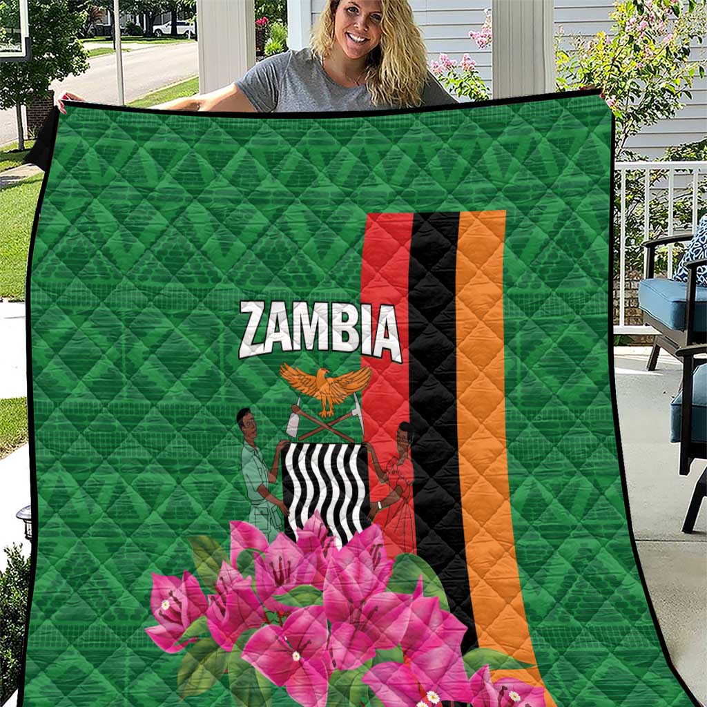 Green Zambia quilt close view with diamond quilting, ZAMBIA text and pink flower artwork