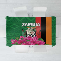 Green tablecloth with purple flowers and multicolor vertical geometric blocks