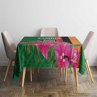 Green tablecloth with purple orchid flowers and multicolor geometric band