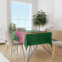 Green floral tablecloth with purple blossoms and orange/black stripes on a dining table