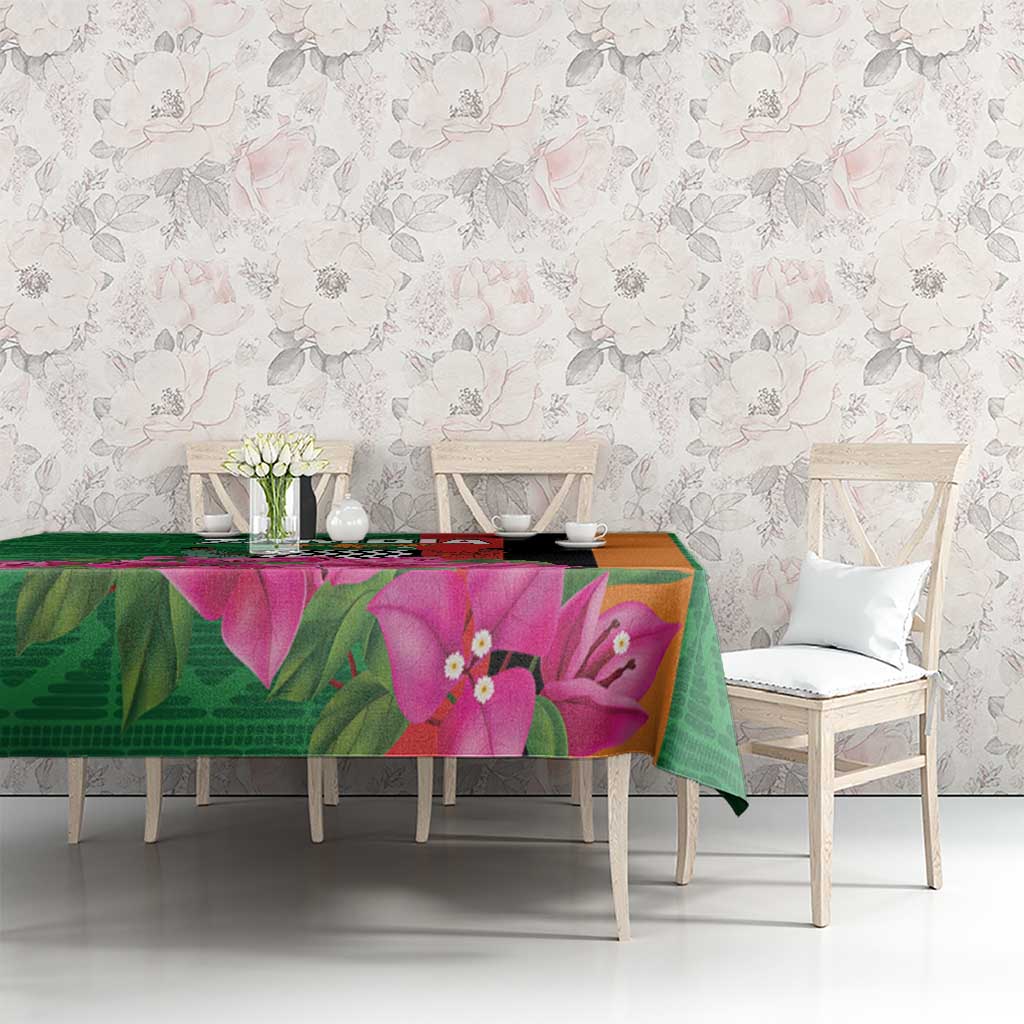 Green tablecloth featuring large pink-purple orchid flowers across the tabletop