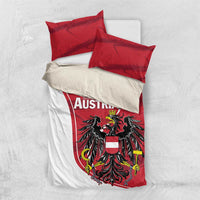 Folded bedding set: white duvet with red Austria crest and red pillowcases