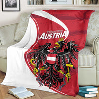 Austria National Day blanket draped on couch with red shield, white stripe, black eagle