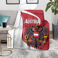 Austria National Day blanket on sofa, red-and-white shield with black eagle centerpiece