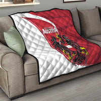 Austria national day quilt on sofa, quilted white and red diagonals with black eagle