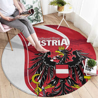 Round red rug featuring Austria National Day lettering and black eagle emblem
