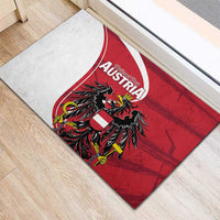 Red rubber doormat with Austria eagle emblem centered over white arc