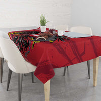 Red tablecloth with black eagle design and centerpiece on dining table