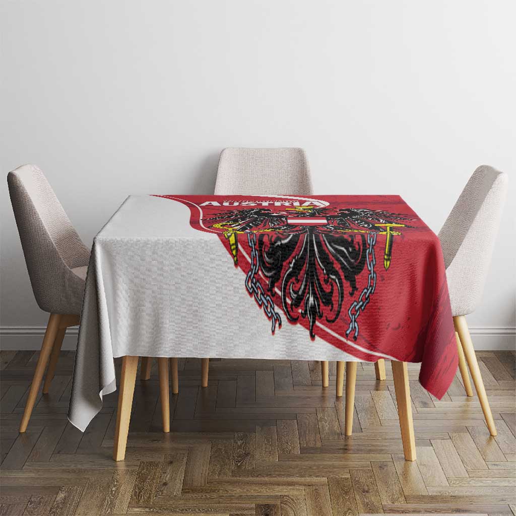 Red Austria tablecloth with black eagle motif and ornate border on table