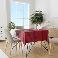 Red tablecloth featuring black eagle and Austria crest on dining set