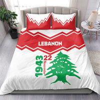 Red and white duvet and pillow set with LEbanon lettering, green cedar tree, and zigzag border