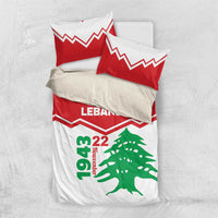 Folded red and white bedding set with pillowcases, LEbanon text, zigzag stripes, cedar tree