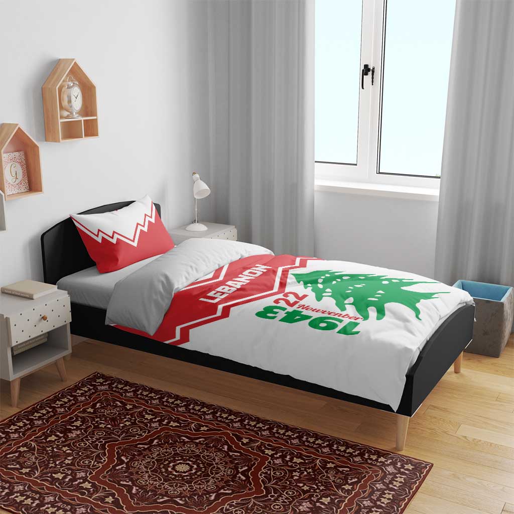 Red and white bedding set on bed with LEbanon lettering and green cedar tree graphic