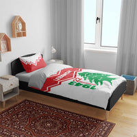 Red and white bedding set on bed with LEbanon lettering and green cedar tree graphic