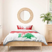 Red and white duvet and pillow set with LEbanon text, green cedar tree, and zigzag stripes