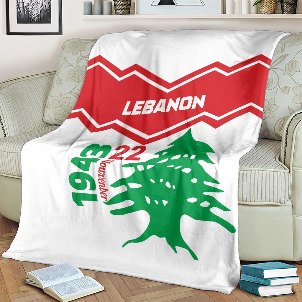 White Lebanon independence day blanket on couch, red zigzag lines and green cedar tree
