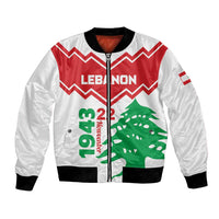 White unisex bomber jacket with front zipper, red zigzag and green cedar graphic