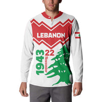 White button sweatshirt on model, red chevron Lebanon graphic with green tree and flag sleeve