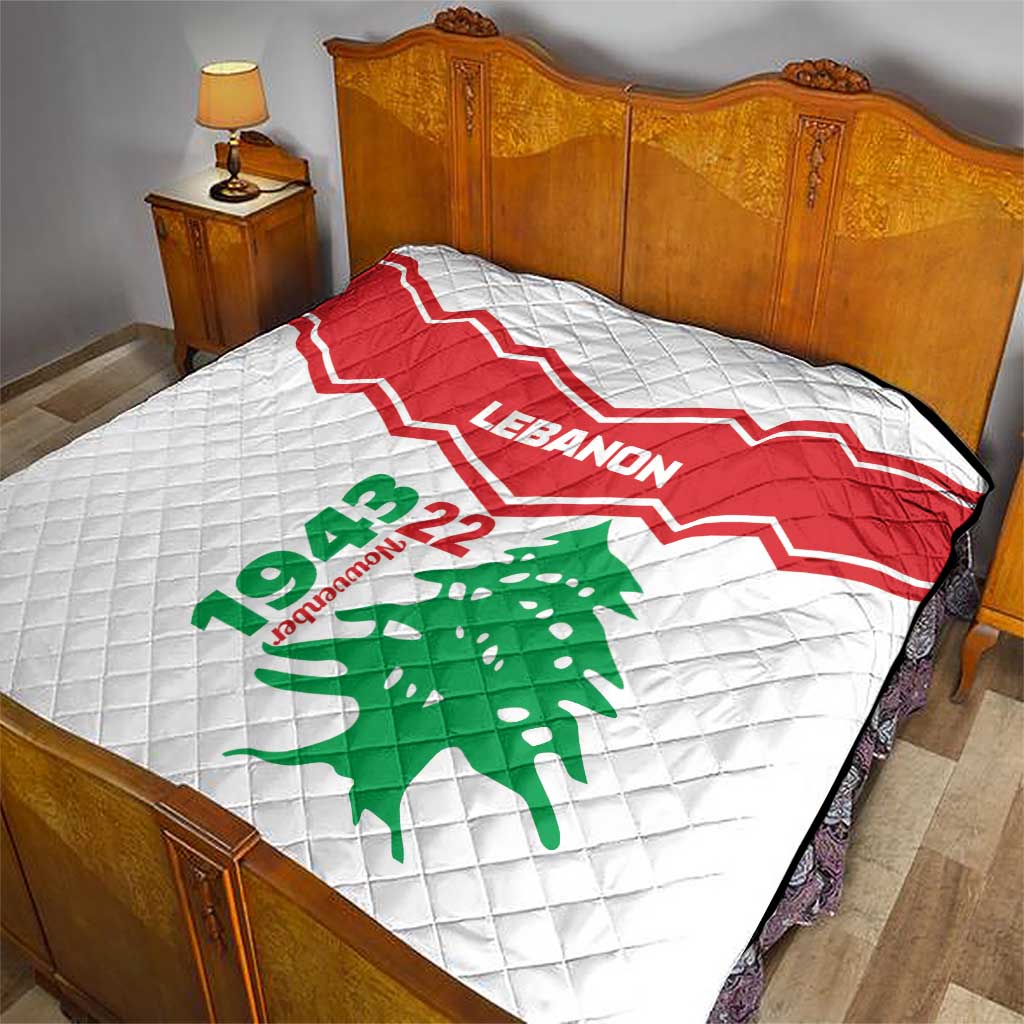 Quilt on bed: red-and-white chevron Lebanon design with green cedar tree and 22