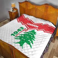 Quilt on bed: red-and-white chevron Lebanon design with green cedar tree and 22